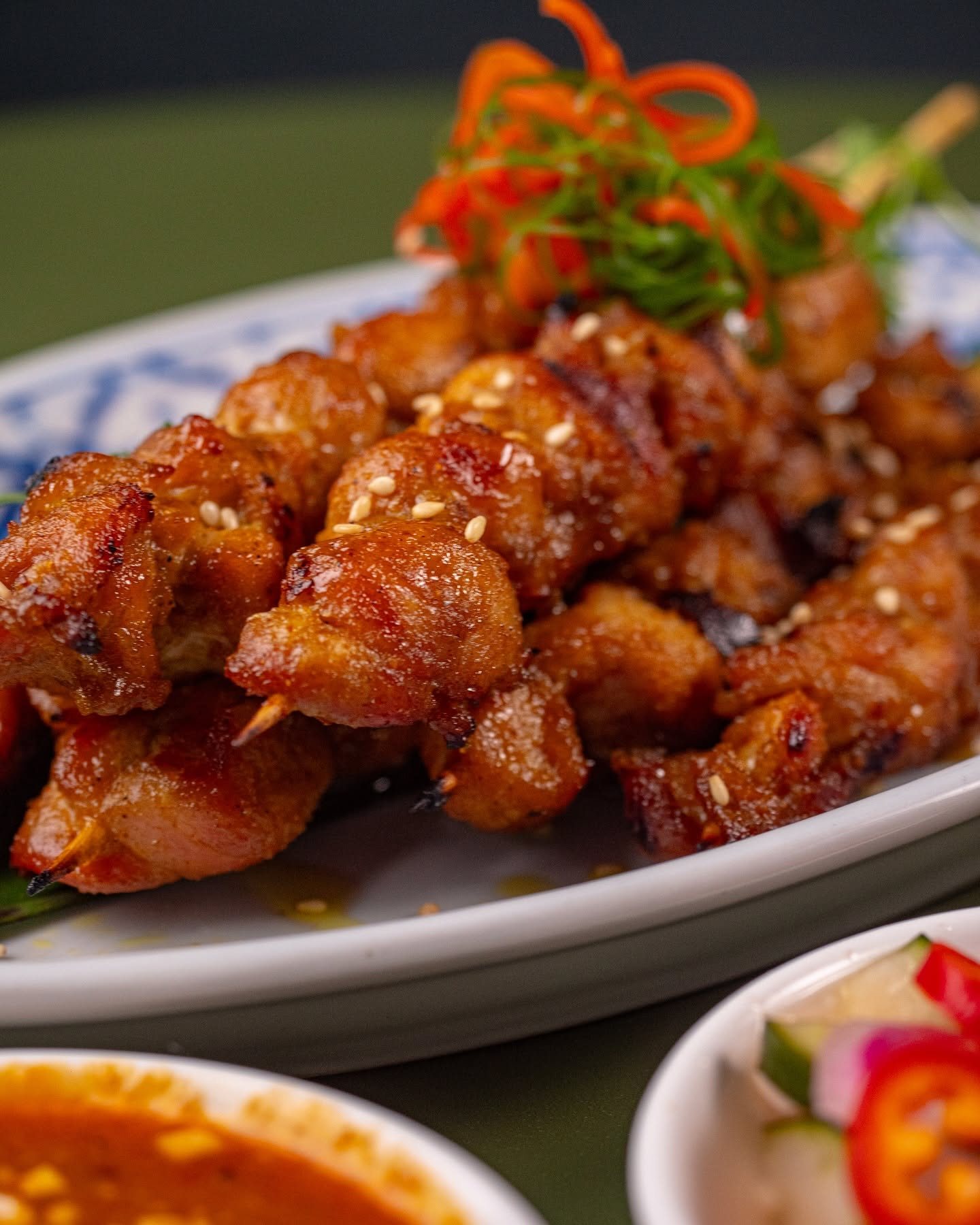Thai chicken poppers glazed and piled on a plate